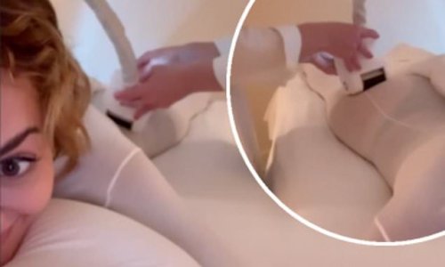 Rita Ora looks incredible in a white body stocking as she gets beauty treatment on her bottom ahead of music video shoot