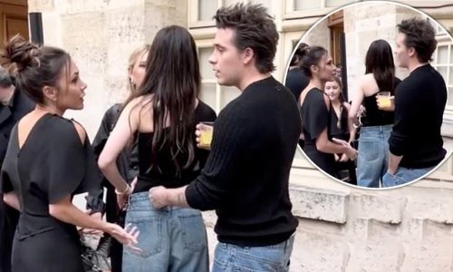 The moment Victoria Beckham reunites with her son Brooklyn as they avidly chat while his wife Nicola Peltz speaks to Cruz's girlfriend Tana Holding before her Paris Fashion Week show amid feud rumours
