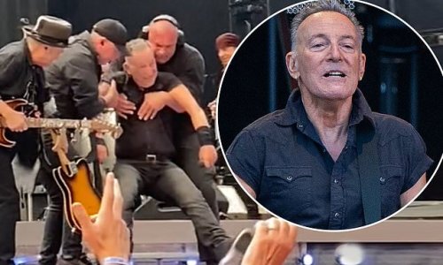 Bruce Springsteen, 73, takes a major tumble on stage as concerned workers rush in to help The Boss onto his feet