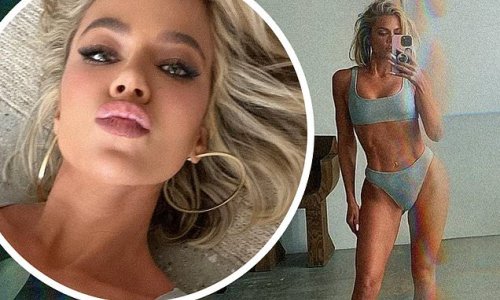 Khloe Kardashian shows off her toned tummy in sparkling silver bikini from her Good American swim collection