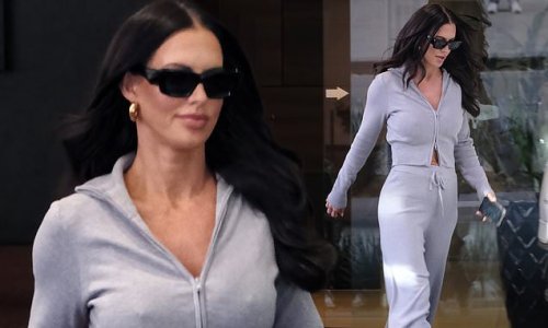 Forget something? Nathan Buckley's ex-girlfriend Alex Pike, 45, puts on an eye-popping display in a tight grey sweatshirt as she leaves a hotel in Melbourne