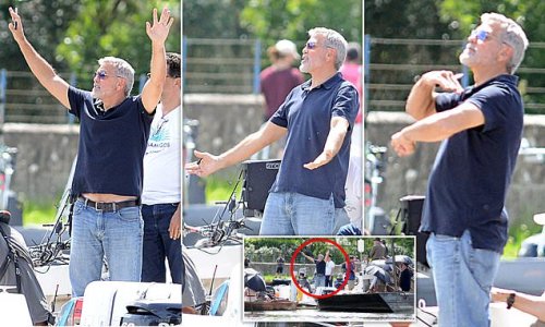 Exclusive: CUT! An exasperated George Clooney, 61, grimaces as he waves down boats motoring into shot as he directs scenes for his 'The Boys in The Boat' project on the River Thames in Oxfordshire
