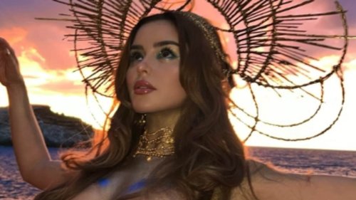 Demi Rose puts on a very busty display as she poses TOPLESS with just gold body paint to retain her...