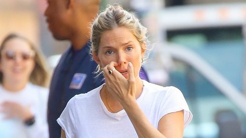 Pregnant Sienna Miller showcases her blossoming bump in a form-fitting white T-shirt and baggy jeans as she takes a stroll in NYC
