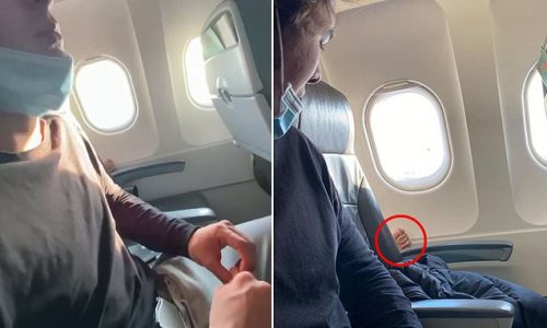 Disgusting moment a person pushes their bare FOOT into another passenger's personal space on a Melbourne to Adelaide flight