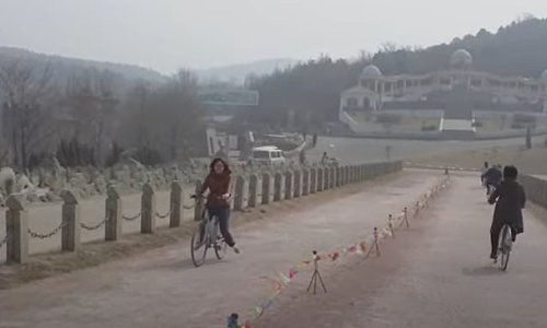 Your eyes DO deceive you: Amazing footage shows the fascinating 'Strange Slope' optical illusion in China where cyclists freewheel 'uphill'