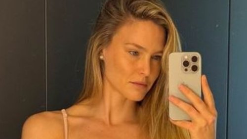 Bar Refaeli displays her incredible figure in nude lace lingerie as she poses for a glamorous mirror...