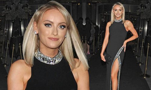 Katie McGlynn puts on a leggy display in a thigh-split black maxi dress ...