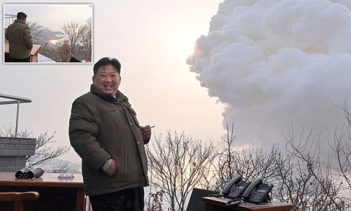 Planning to turn America to ash? Laughing Kim Jong Un puffs on a cigarette as he is dwarfed by a smoke cloud while supervising test of new missile that is harder to detect and can reach mainland US