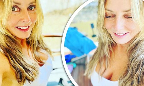 'Working out in the heat': Carol Vorderman, 61, puts on a busty display in white workout gear as she shares a throwback snap from South Africa after filming I'm A Celeb All Stars