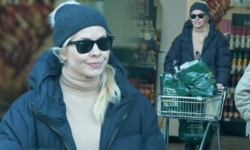 Holly Willoughby bundles up in a black padded jacket and a beanie hat while out on a shopping trip in West London