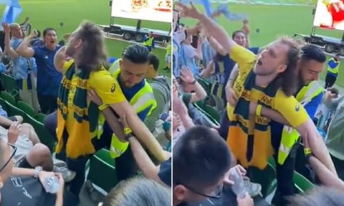 Moment a mulleted Socceroos fan has to be restrained by security as he gets into the face of an Argentina supporter during Australia’s brave World Cup loss