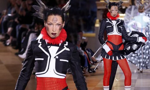 Bella Hadid flashes her underwear in a cartoon couture ensemble as she takes to the runway at Thom Browne show during Paris Fashion Week