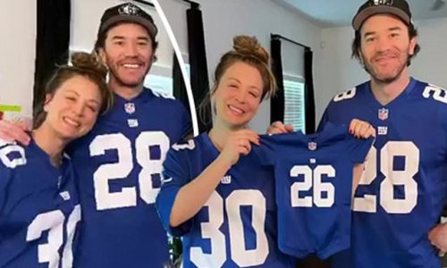 Pregnant Kaley Cuoco displays her bump in a New York Giants jersey and shows off adorable babygro with beau Tom Pelphrey as she celebrates her upcoming 37th birthday