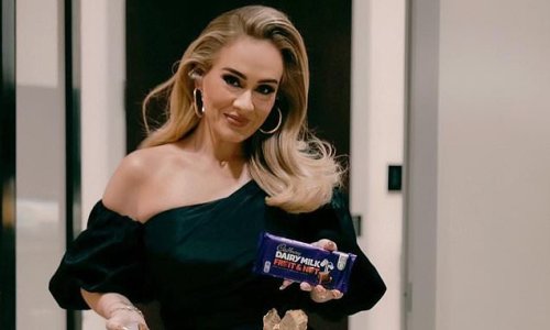Adele enjoys a taste of home as she poses with a Cadbury Fruit & Nut chocolate bar before heading on stage in Las Vegas