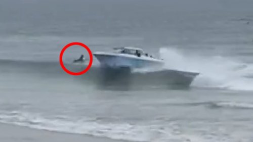 Dramatic moment migrants in a speed boat nearly run over surfers in the water in California as they...