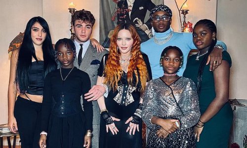 Madonna, 64, shares rare family photo with all SIX of her children - ages 26 to 10 - on Thanksgiving as she models a low-cut black dress