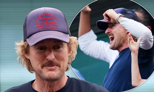 Owen Wilson punches the air with joy as he joins fans at Stamford Bridge supporting Chelsea FC during their first home game of the season