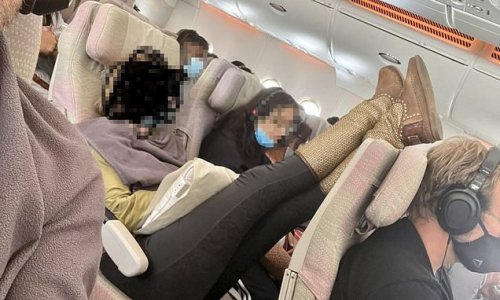 The picture proving Australia has completely lost the plot - as grubby feet-on-seat act is excused for 'health reasons'