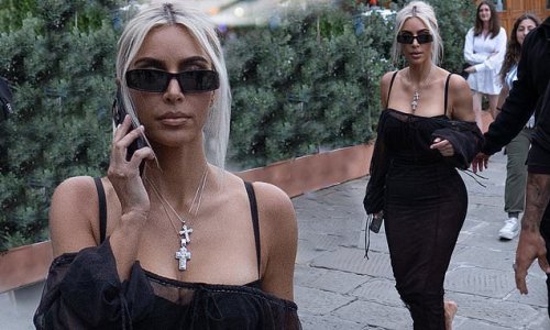 EXCLUSIVE: Barefoot Kim Kardashian exhibits her hourglass figure in a tight black dress as she heads to sister Kourtney's pre-wedding bash - but remains tight-lipped about the big day