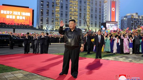 Un size does not fit all: Kim Jong Un wears baggy trousers as he walks the red carpet at ceremony to...