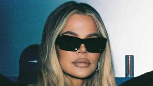 Khloe Kardashian glams up in a fitted mini dress with stylish sister Kylie Jenner as she supports...