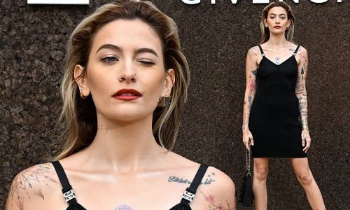 Paris Jackson showcases her numerous tattoos and wows in a black dress as she attends Givenchy PFW show