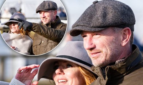 Geri Horner looks effortlessly chic in a grey coat and matching fedora as she joins husband Christian at the Heythrop Hunt Point-to-Point races