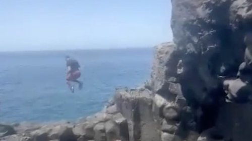 Horrifying moment Brit slams into rock after misjudging leap into pool