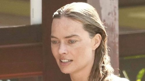 Margot Robbie shows off her figure in a grey bikini as she enjoys a dip in the sea in Queensland - seven months after giving birth to her baby boy