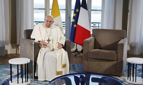 Moment Pope Francis, 86, slaps his hand down and glares at an empty chair beside him after being made to wait for a meeting with French President Emmanuel Macron
