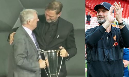 The brilliant moment Jurgen Klopp pulls Sir Alex Ferguson into his photograph while celebrating winning Manager of the Year trophy... after Manchester United legend hilariously admitted handing Liverpool boss the gong was 'absolute agony']