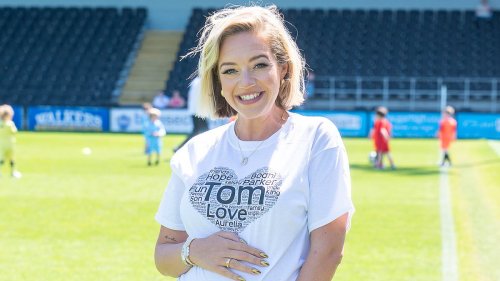Pregnant Kelsey Parker cradles her baby bump as she leads stars at annual charity football match in memory of her late husband Tom