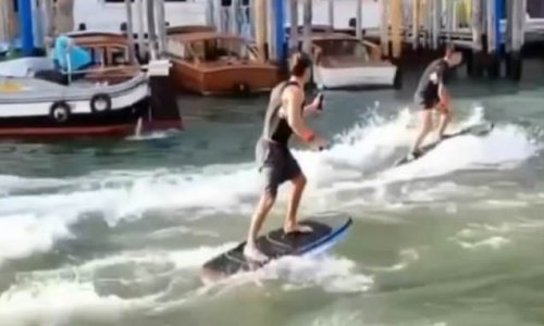 Uproar in Venice as two 'imbecile' Australian tourists are filmed speeding down city's famed Grand Canal on £20,000 electric hydrofoils
