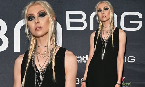 Taylor Momsen of Gossip Girl fame rocks a glam goth girl look in a LBD with braids and dramatic eye makeup at pre-Grammy party in West Hollywood