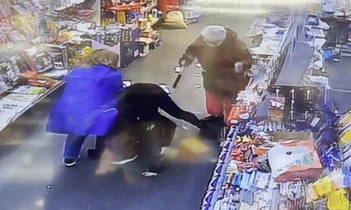 Moment heroic 4ft 11in grandmother, 63, tackles hammer-wielding thief in botched newsagent raid and sits on him until police arrive
