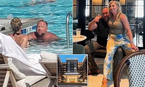 EXCLUSIVE: Swimming upstream! Alex Jones is seen chilling out in the pool at luxe Omaha hotel after he was ordered to pay $50million to families of the Sandy Hook shooting