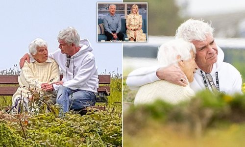 The moment Phillip Schofield came clean to his mother about his sacking: Shamed star embraces his mum, 87, on a bench overlooking the sea - as Holly Willoughby returns to the This Morning sofa tomorrow with 'honest personal statement' on the scandal