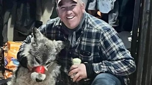 Wyoming hunter, 42, poses with exhausted wolf he tortured and paraded around his local bar with its...