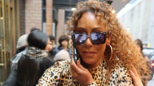 Mel B gets caught by a swarm of fans as she steps out in a sizzling leopard print catsuit during her...