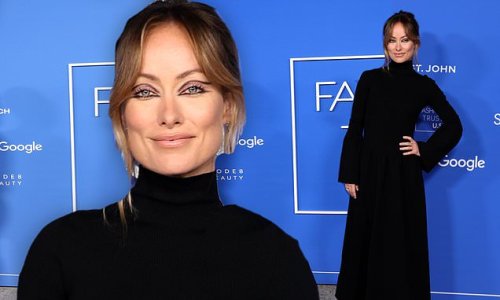 Olivia Wilde looks elegant in a black gown and platform boots at Fashion Trust Awards in LA... after flaunting her 'tramp stamp' on Instagram