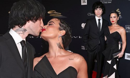 Demi Lovato looks alluring in a black strapless dress as singer makes red carpet debut with new beau Jordan Lutes at Clive Davis' pre-GRAMMY gala in LA
