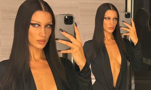 Bella Hadid leaves little to the imagination in VERY low-cut silk shirt while backstage during Versace's Milan Fashion Week show