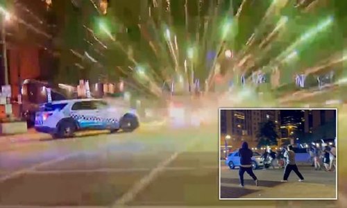 Terrifying moment Chicago street racers attack cops who tried to stop them doing donuts in city's Loop neighborhood - just hours before July 4 massacre that killed six
