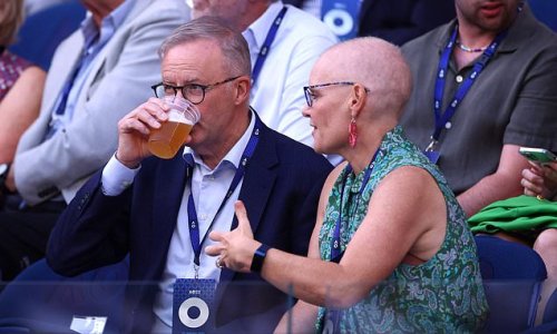 Anthony Albanese enjoys a beer in the stands during Novak Djokovic's win over Tommy Paul at the Australian Open as Prime Minister REFUSES to weigh in on Vladimir Putin row with Serbian's father