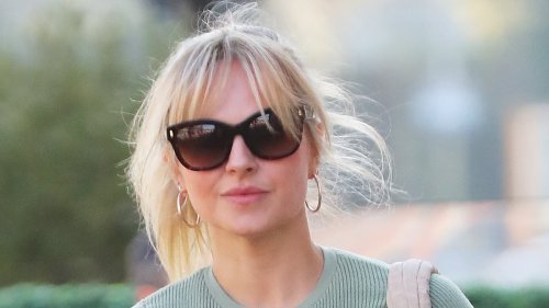 Tina O'Brien hides her wedding ring finger under her coat as she steps out for the FIRST time since sparking split rumours from husband Adam Crofts