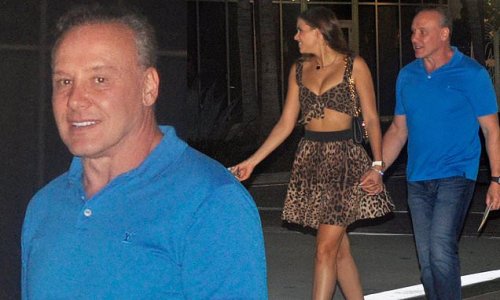 Lenny Hochstein, 56, holds hands with leggy model girlfriend Katharina Mazepa, 27, during night out in Miami... amid bitter split from estranged wife Lisa Hochstein
