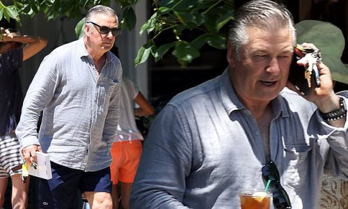 Alec Baldwin rocks a grey linen shirt and navy blue shorts for a business meeting in the Hamptons