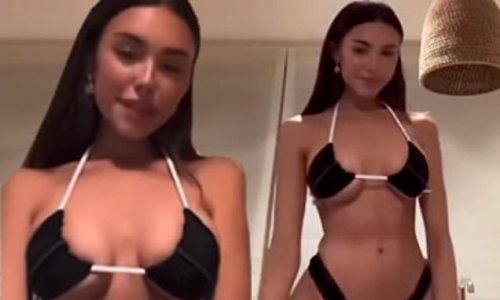Madison Beer showcases her flat midriff and ample cleavage in tiny black and pink bikini in