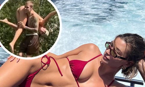Hailey Bieber poses in a red bikini while on a yacht before horsing around with husband Justin Bieber during Mediterranean vacation